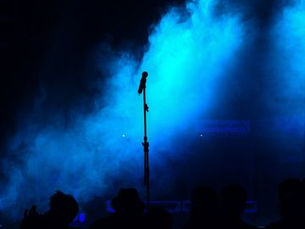 Single microphone on smoky blue background