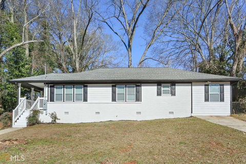 a white house with black shutters and a gray roof
