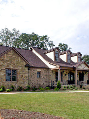 a large brick house with a brown roof