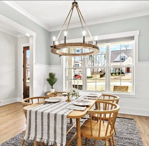 a dining room with a table and chairs and a chandelier - SR Developers