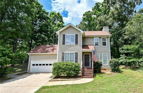 the front of a house with an american flag on the porch