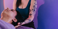 Payton Brown, a Licensed Massage Therapist, providing intentional therapeutic bodywork in a serene Woodinville studio.