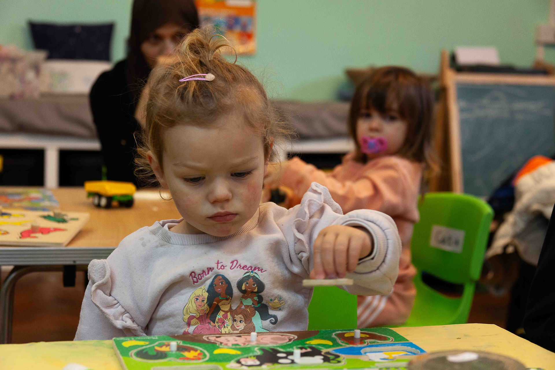 Toddler playing with shapes puzzles