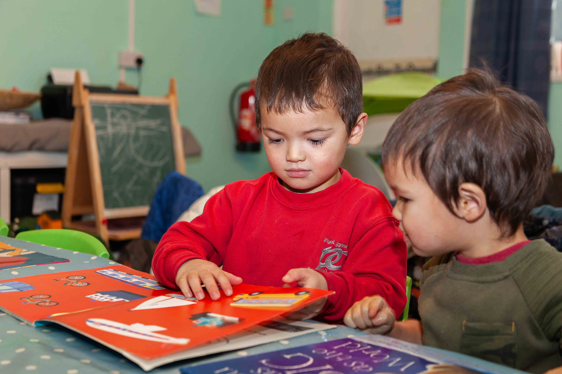 Boys looking at a book together
