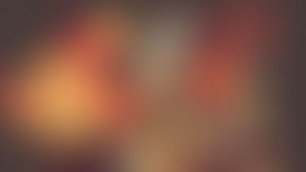 Multi-eyed creature in surreal environment with yellow planets and orange smoke, holding ritualistic object.