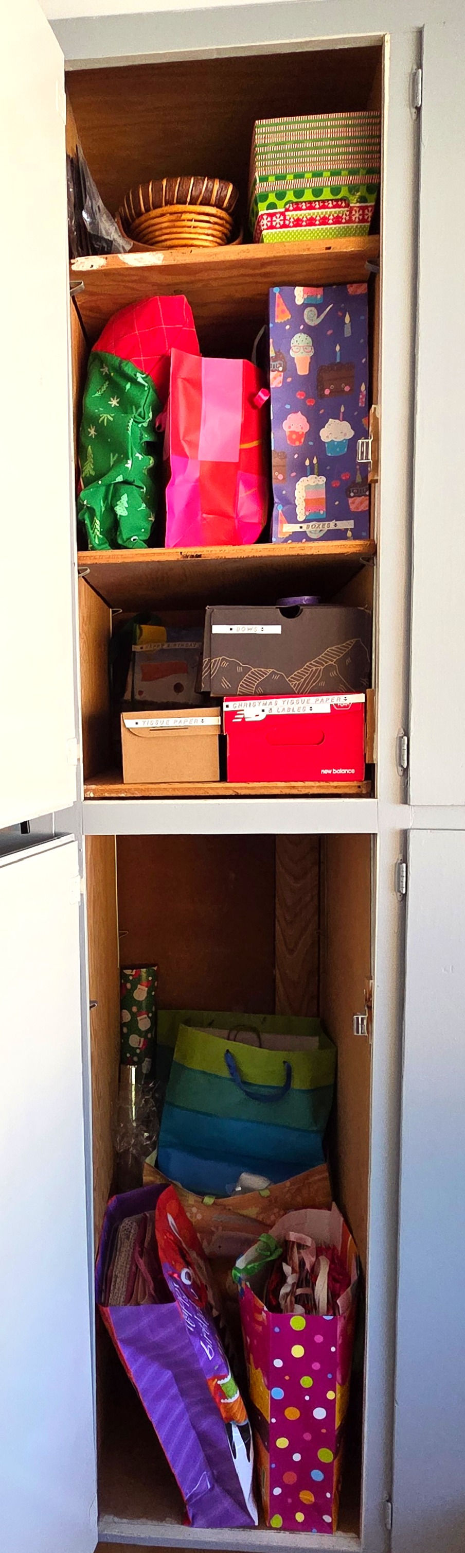 After/ gift wrap organized and stored in cabinet