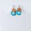 Thumbnail: Turquoise and brown earrings on a white mannequin, TaguArtsy fashion jewelry.