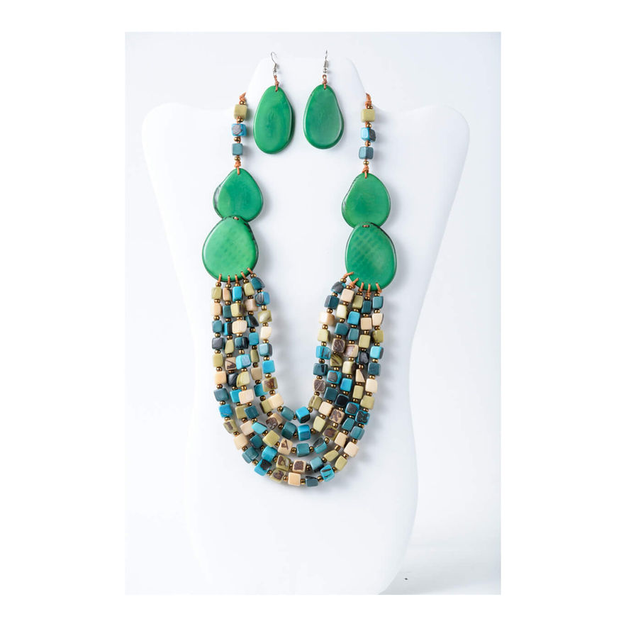 Green Tagua necklace and earrings set on white jewelry stand.  simple fashion accessory. handmade, organic and natural, lightweight. 