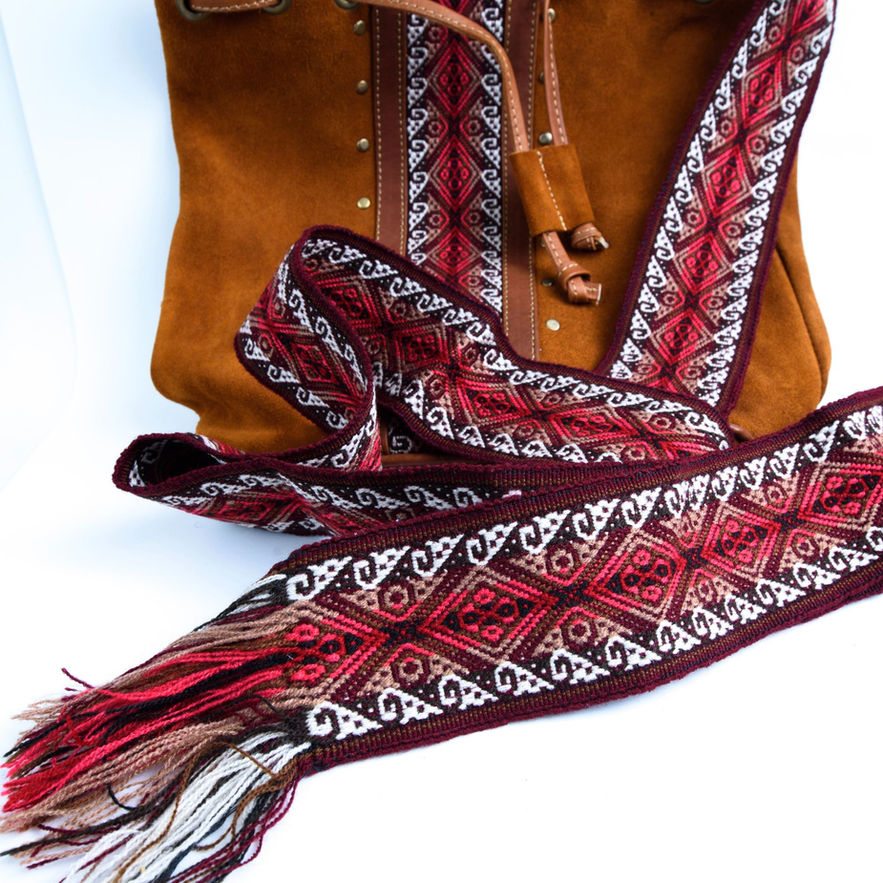 Brown suede bag with red and cream embroidered strap