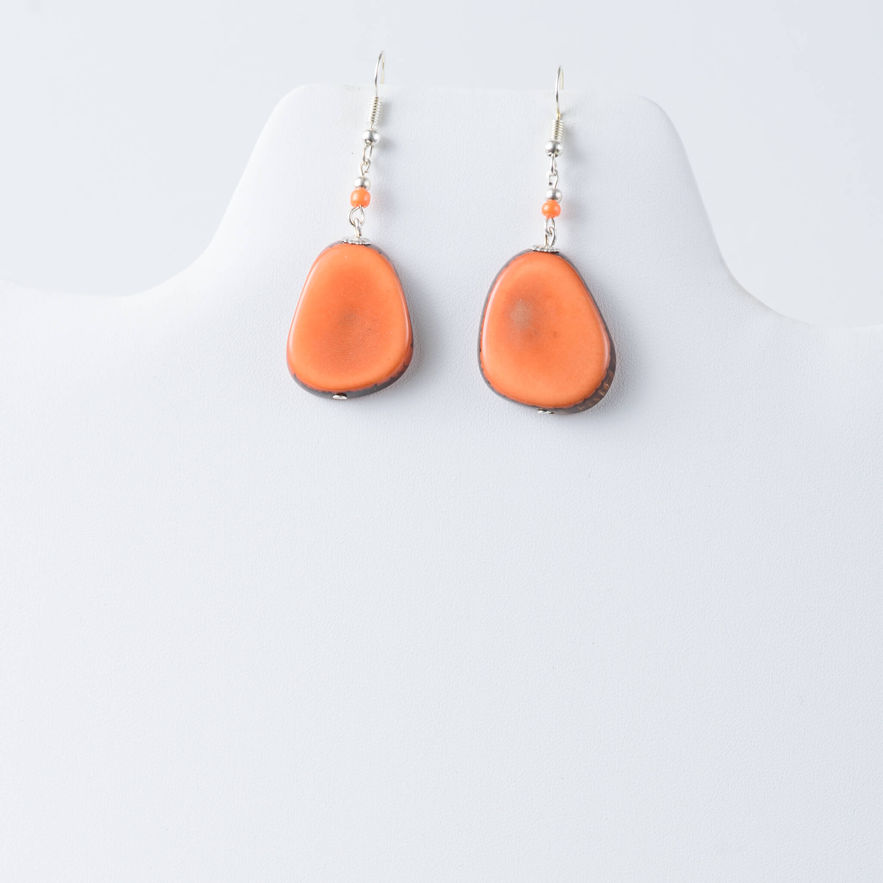 Orange tagua earrings on display