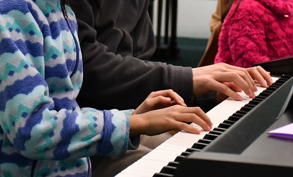 A parent and child learning together in a group piano Creative Keyboards class at Music Works Northwest.