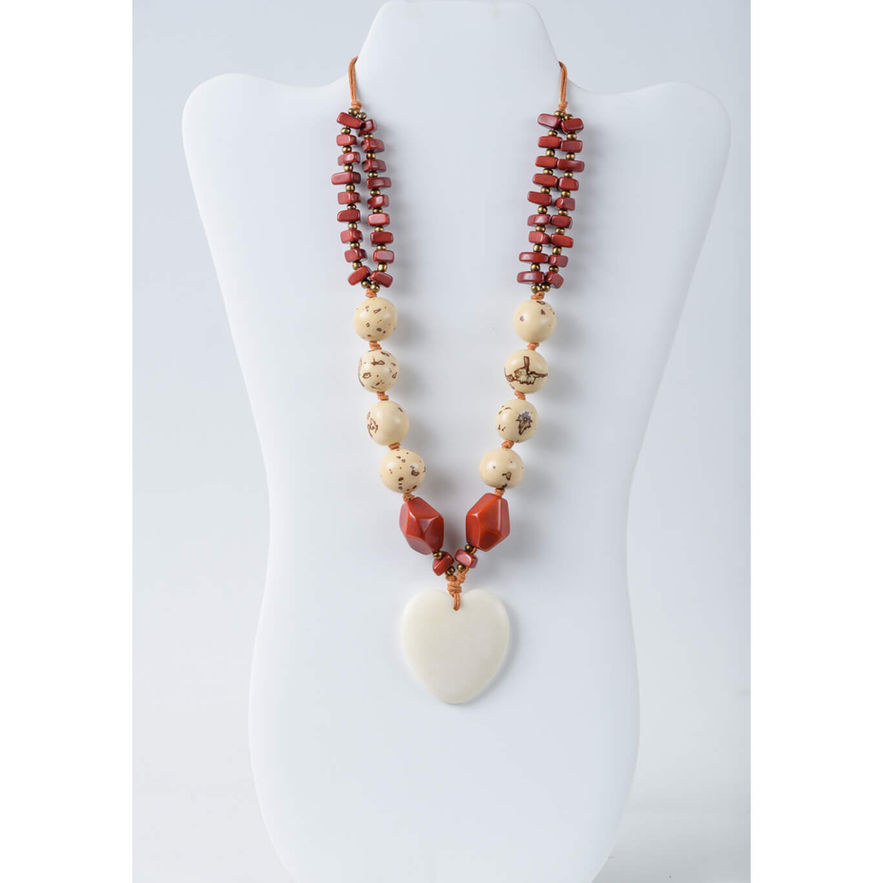 Artisan necklace with red, beige beads, and large off-white heart pendant