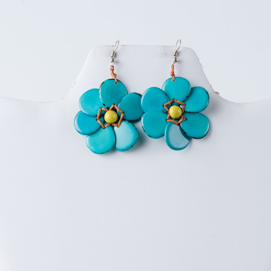 Turquoise Hibiscus Flower Tagua Earrings on display with white background, TaguArtsy