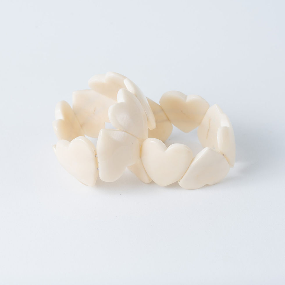 Handmade natural tagua heart bracelet in Ivory/White featuring 8 to 10 polished heart beads