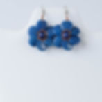 Two blue flower earrings made from tagua nut