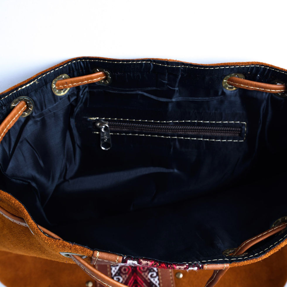 Tan leather drawstring bag interior with zippered pocket