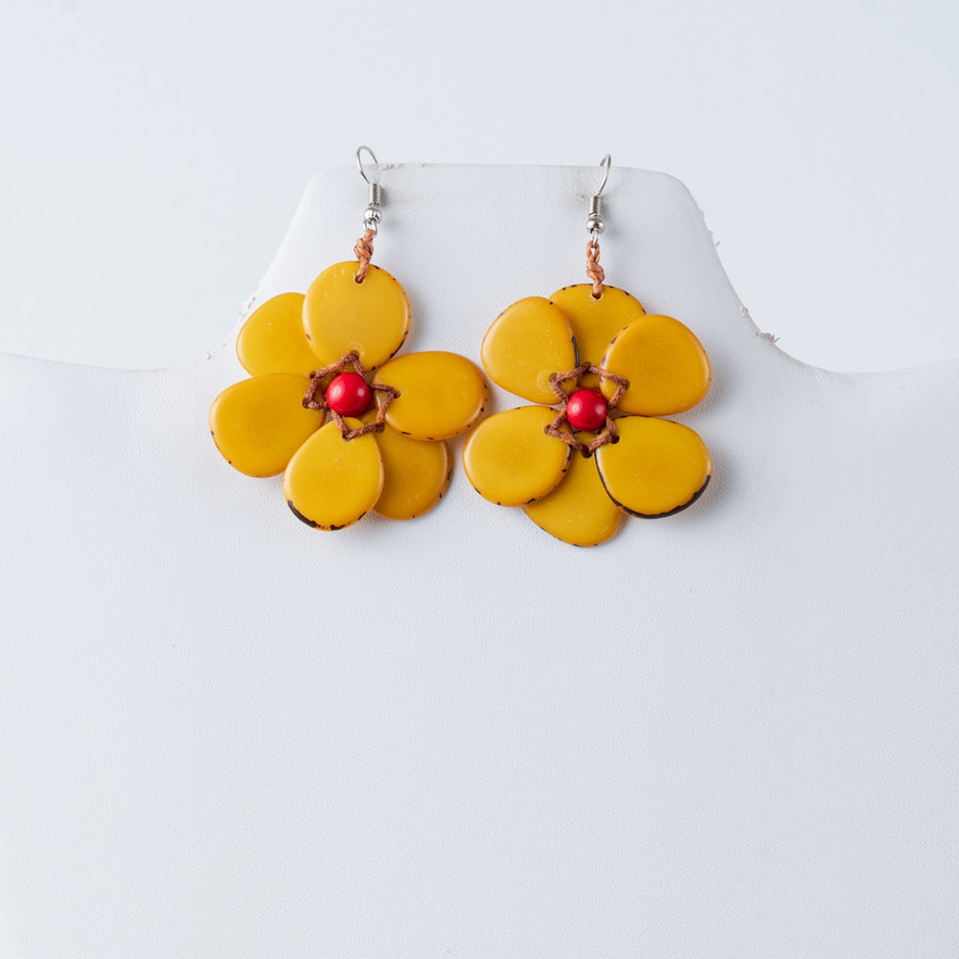 Yellow flower-shaped earrings, Hibiscus Flower Tagua Earrings, red bead center, white background TaguArtsy