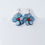 Thumbnail: Blue flower earrings with red centers, displayed on white background, TaguArtsy.