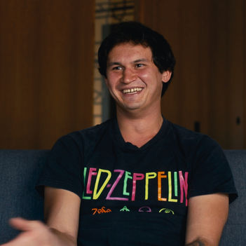 Uzbek Man sitting on a couch for a Christian testimony video interview