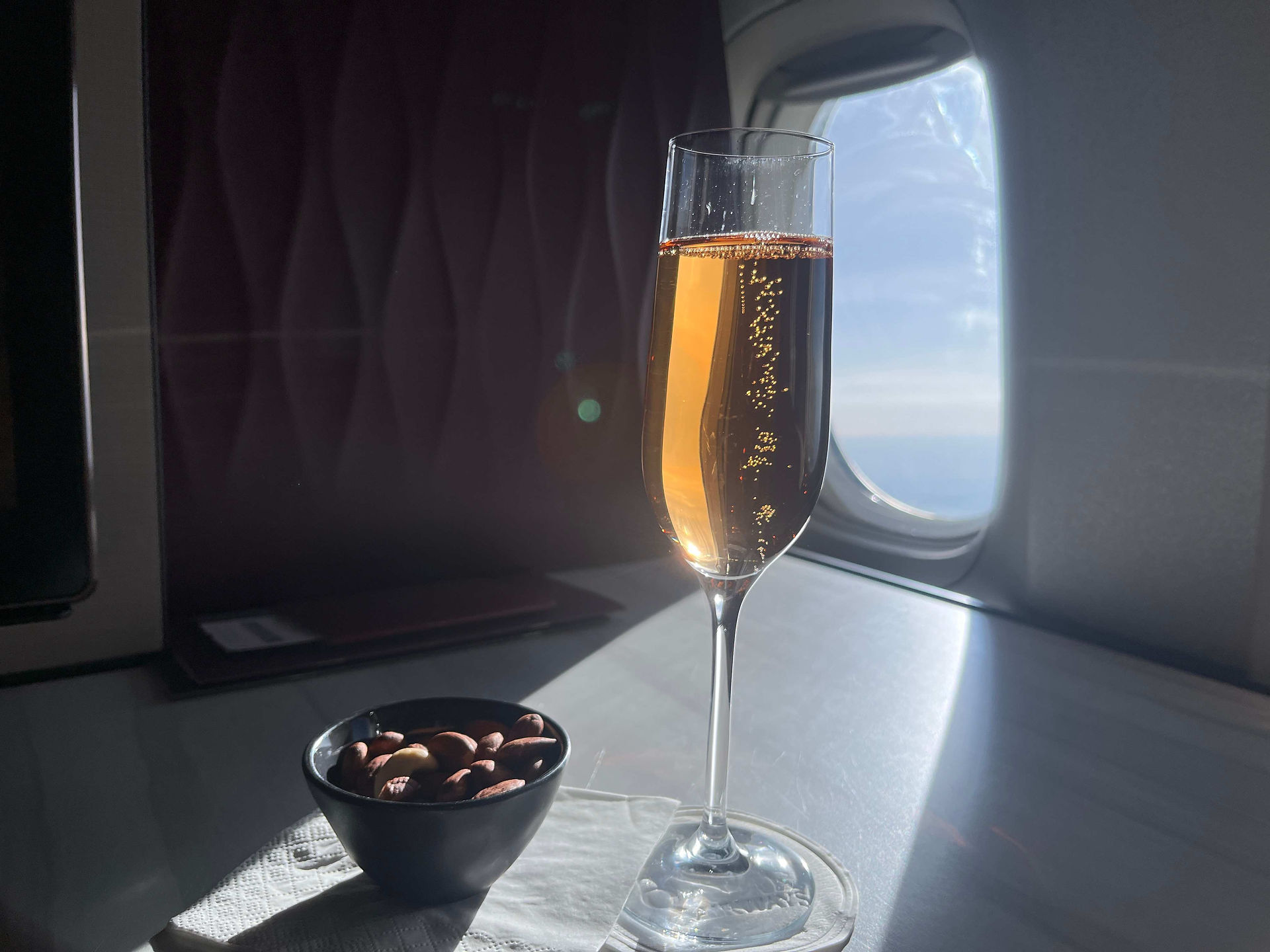 Champagner und Nüsse in der Qatar Airways Business Class in der Qsuite in der Boeing 777-300ER