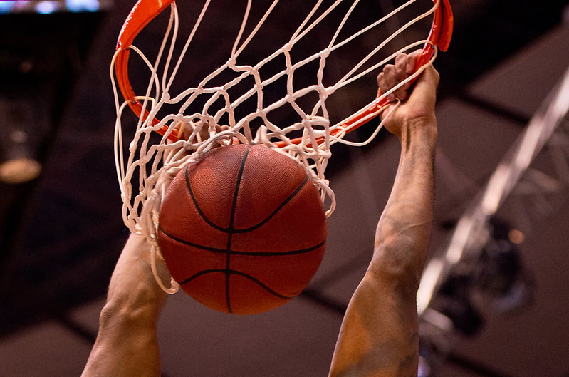 Man dunking a basketball into a hoop