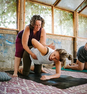 roni friedman adjusting a yoga student