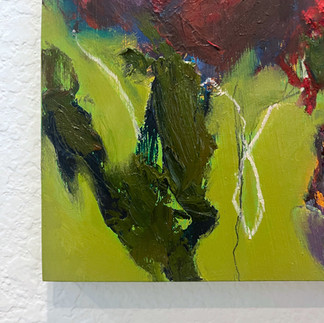 detail of an unframed painting on panel hanging on the wall