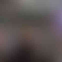 A group smiles and chats while two other women lean in for a hug