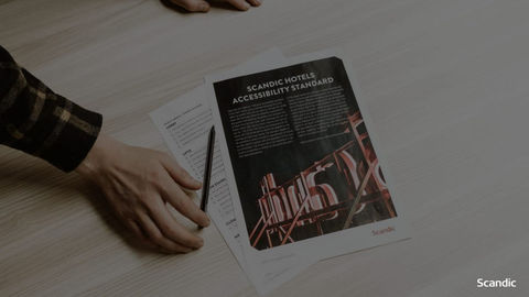 Hand reaching for a pamphlet