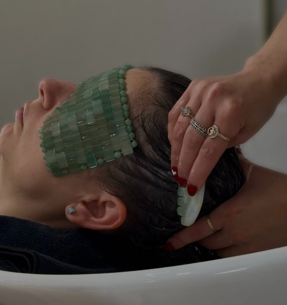 Client receiving luxury organic jade gua sha scalp treatment at TRU Hair Salon, an eco-friendly hair salon in Colorado Springs