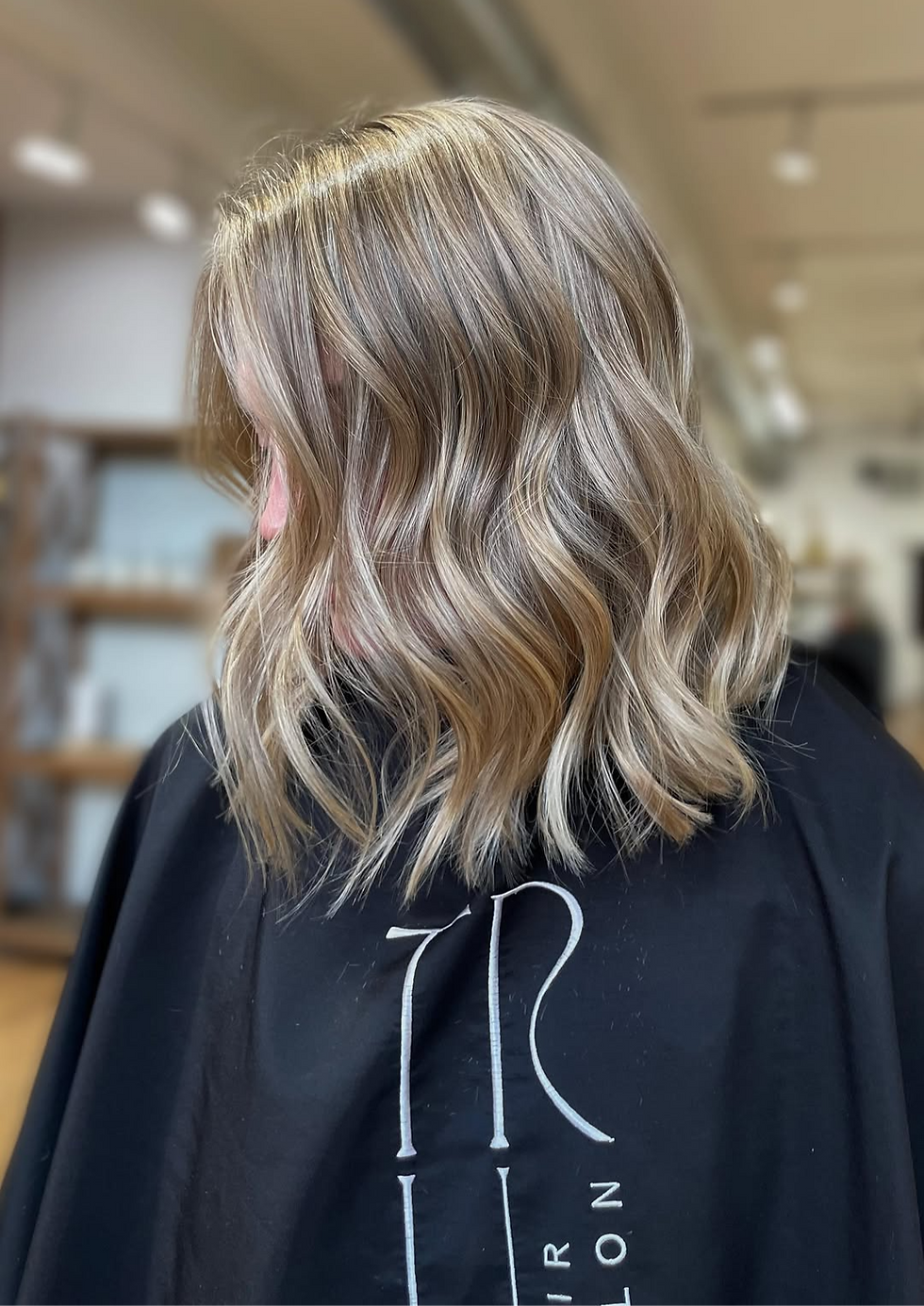 Blonde client showing off a fresh short haircut at TRU Hair Salon in Colorado Springs, featuring sleek, modern styling with textured layers and vibrant color, highlighting the organic salon’s expert precision in creating trendy haircuts
