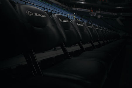 dark image of Lexus branded chairs set up in a venue