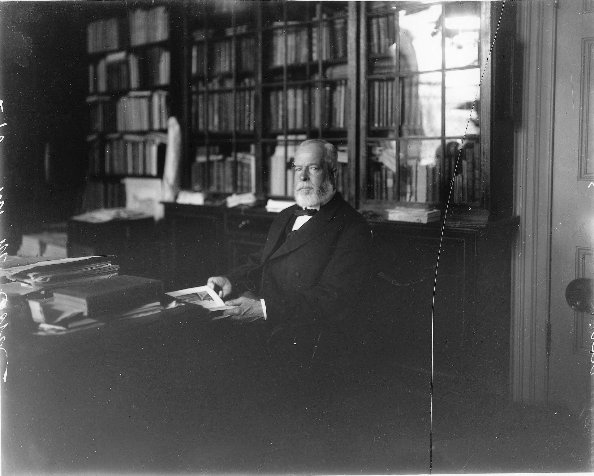 David Ross McCord sitting in his library, about 1916.