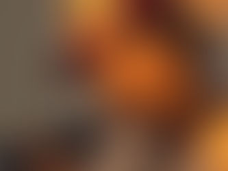 Enzo Ferro segurando um microfone durante sessão de gravação, usando boné vermelho e camisa clara, com iluminação quente e expressão introspectiva.