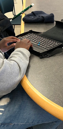 Photo from my assistive technology research, individual is using a brain keyboard and lapt