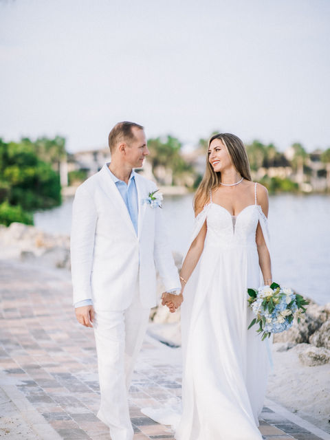 Bride and groom walking along the water in the Florida Keys.