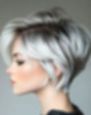  Profile view of a woman with a stylish gray and white bob, wearing a dark sweater.