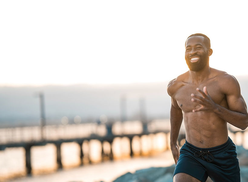 Fit man running and smiling