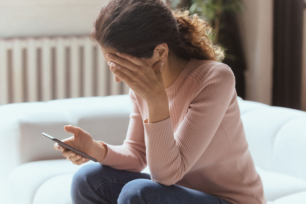 Woman looking at cell phone upset