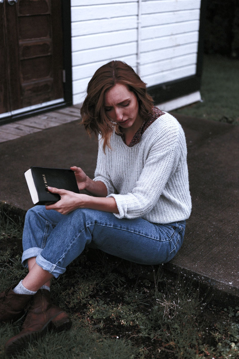 Woman sitting and holding Bible
