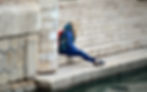 girl stitting on steps by ourdoor water