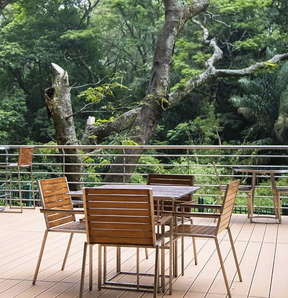 Outdoor seating area with wooden table and chairs on deck