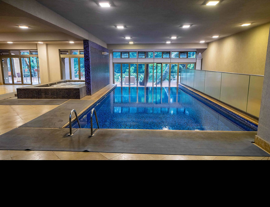 Indoor swimming pool with glass doors at the Amenities spa