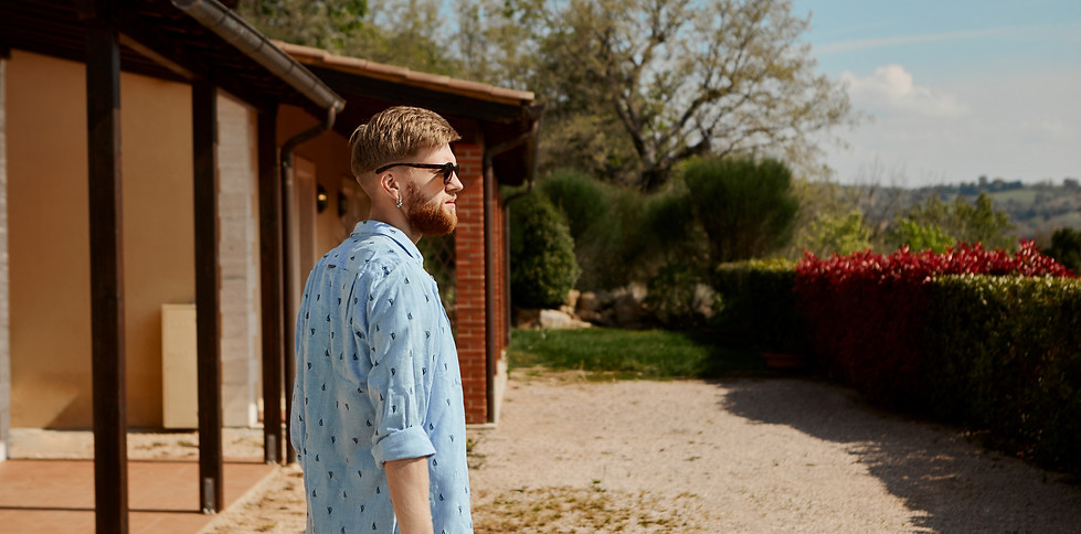 rear-view-trendy-bearded-young-male-wearing-sunglasses-summer-clothes-carrying-suitcase.jp