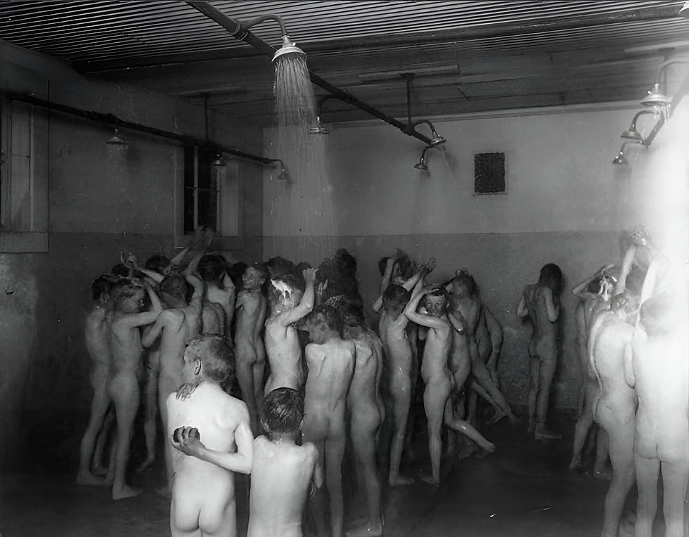 A large group of boys share a communal shower, 1906. (Public Domain)