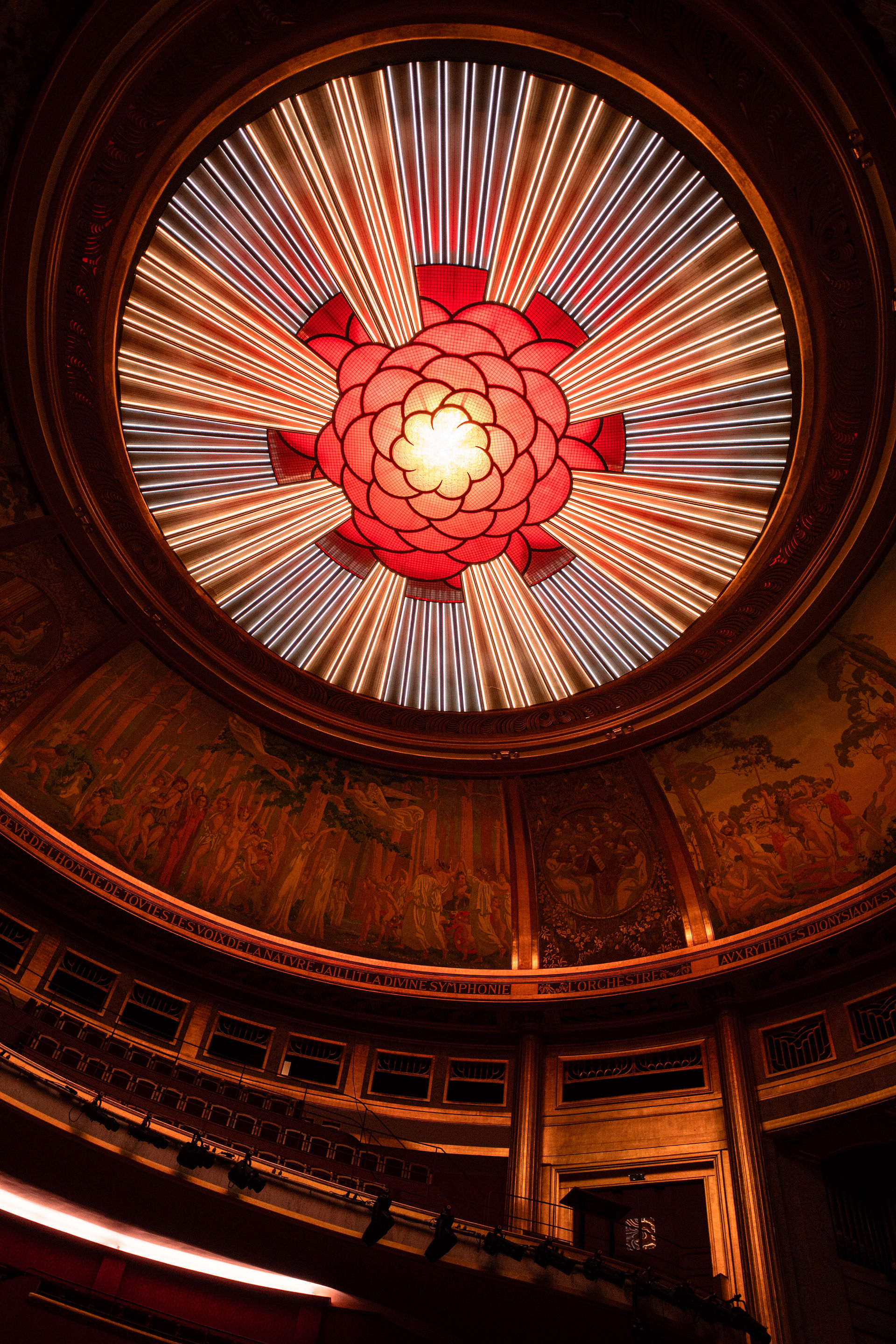 Coupole et fresque du théâtre des Champs-Élysées illuminées en rouge 