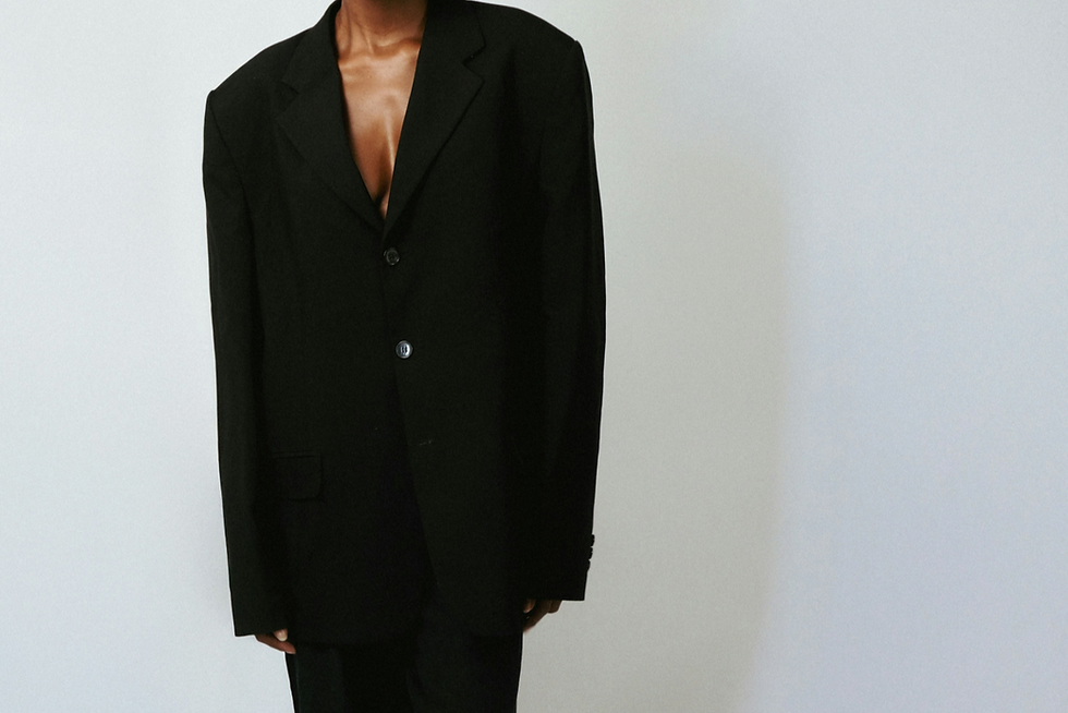 A woman wearing a fitted black blazer