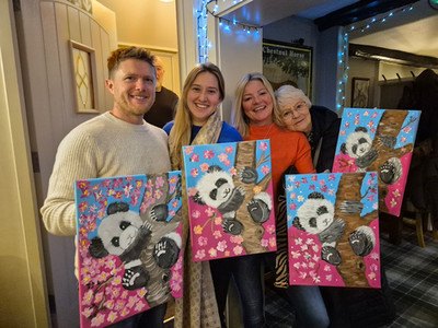 Happy family group holding paintings of pandas