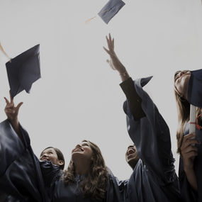 Students tossing their graduation caps in the air.