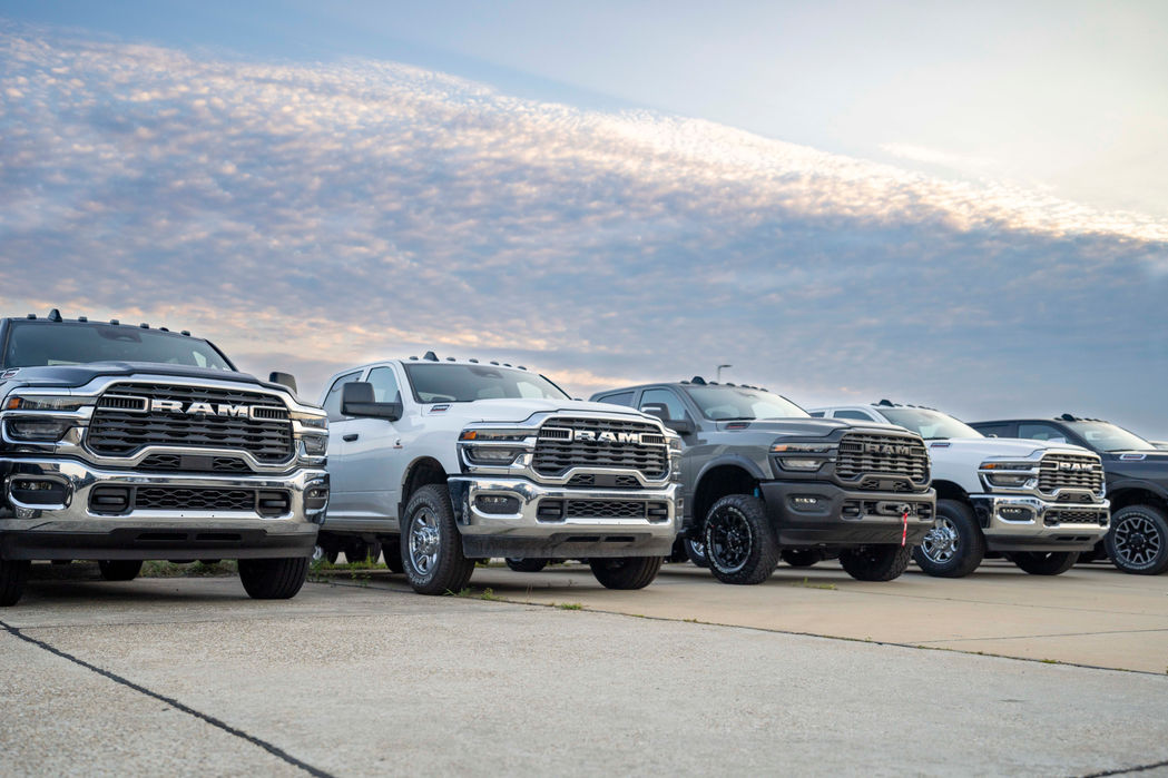 A line up of RAM trucks on a dealership lot posed for a custom photography shoot.